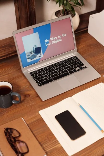 A sleek office desk setup featuring Apple devices: iMac, MacBook, and iPad.