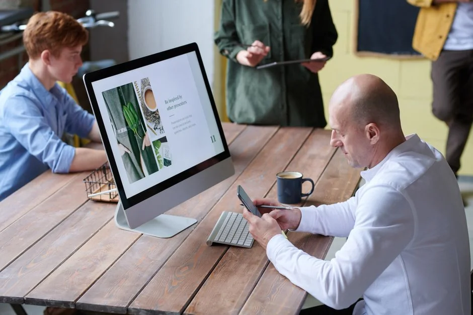 A contemporary workspace with two computer monitors showing web design projects, highlighting technology and productivity.